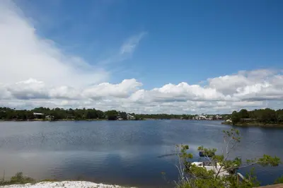 a large lake with a boat in the water at All's Well in Santa Rosa Beach
