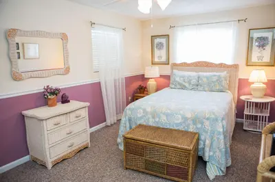 a bedroom with a bed and a mirror at All's Well in Santa Rosa Beach
