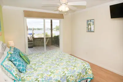 a bedroom with a bed and a ceiling fan at All's Well in Santa Rosa Beach