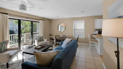 a living room with a blue couch and a table at Beachwood Villas 14B - Simply Seagrove in Santa Rosa Beach