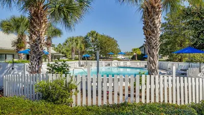 a white fence with palm trees and a pool at Beachwood Villas 14B - Simply Seagrove in Santa Rosa Beach