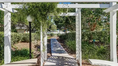 a white pergola with a walkway at Beachwood Villas 14B - Simply Seagrove in Santa Rosa Beach