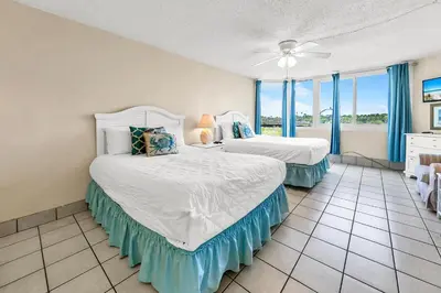 a bedroom with two beds and a large window at Top of the Gulf 324 in Panama City Beach