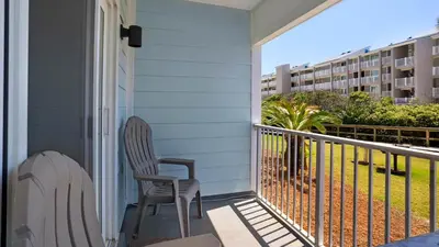 a balcony with two chairs and a condo at Beachside Villas 612 in Santa Rosa Beach