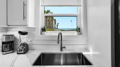 a kitchen with a sink and a window at Beachside Villas 612 in Santa Rosa Beach