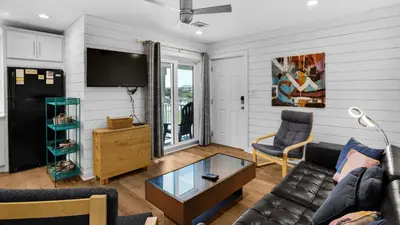 a living room with a couch and a tv at Beachside Villas 612 in Santa Rosa Beach