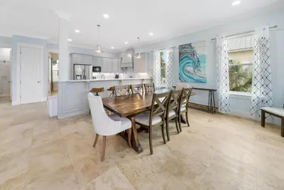 a kitchen and dining room with a table and chairs at The Retreat in Santa Rosa Beach