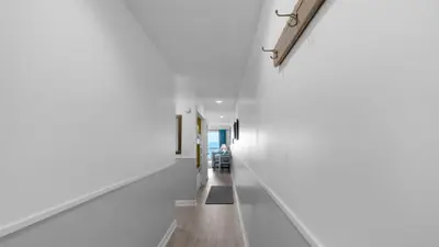 a hallway with white walls and wood floors and a long white wall at Mistral 11 in Seacrest