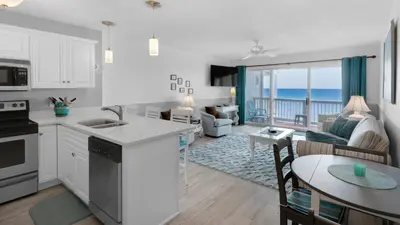a kitchen and living room with a view of the ocean at Mistral 11 in Seacrest