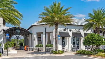 a building with palm trees in front of it at Mistral 11 in Seacrest