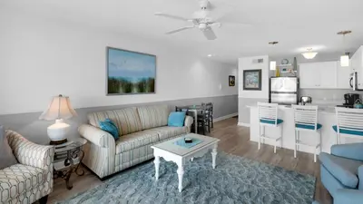 a living room with a couch and a table at Mistral 11 in Seacrest