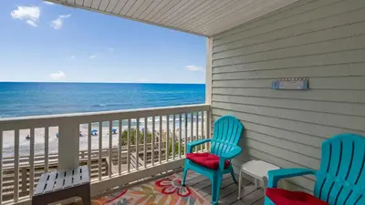 two chairs on a balcony with the beach at Mistral 11 in Seacrest