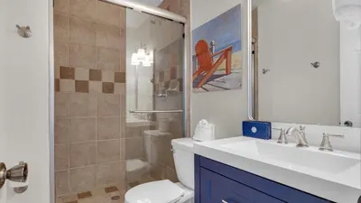 a bathroom with a toilet and a sink and a shower at Blue Nine 5 in Panama City Beach