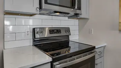 a kitchen with a stove and a microwave at Blue Nine 5 in Panama City Beach