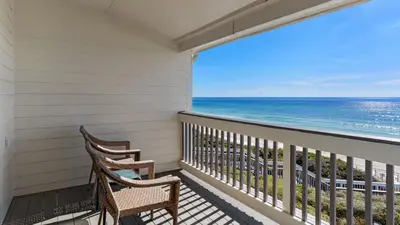 a balcony with two chairs looking out at the ocean at Blue Nine 5 in Panama City Beach