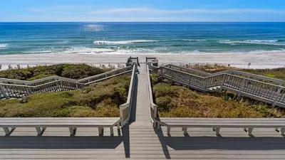 a stairway leading to a beach with two benches at Blue Nine 5 in Panama City Beach