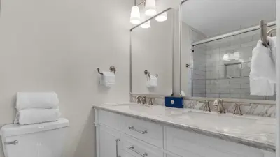 a white bathroom with a sink and a mirror at Blue Nine 5 in Panama City Beach