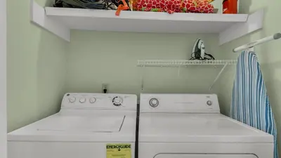 a white laundry room with a washer and dryer at Blue Nine 5 in Panama City Beach