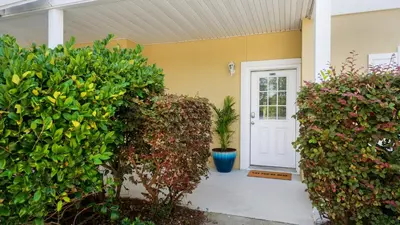 a front door of a house with plants at Heron's Watch 5101 in Santa Rosa Beach