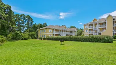 a large yard in front of two large houses at Heron's Watch 5101 in Santa Rosa Beach