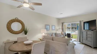 a living room with a table and a couch at Heron's Watch 5101 in Santa Rosa Beach