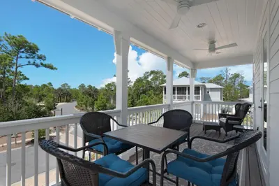 a screened porch with a table and chairs on it at 9 Prairie Pass in Santa Rosa Beach