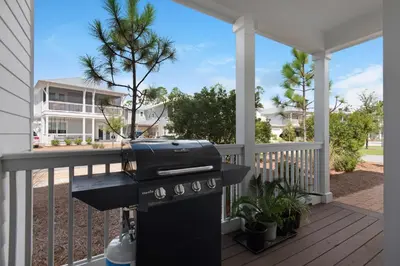 a grill on a porch with a house at 9 Prairie Pass in Santa Rosa Beach