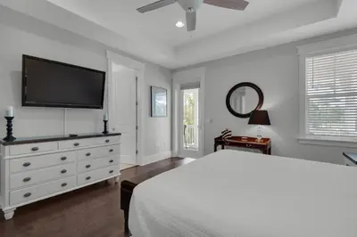 a bedroom with a bed and a flat screen tv at 9 Prairie Pass in Santa Rosa Beach