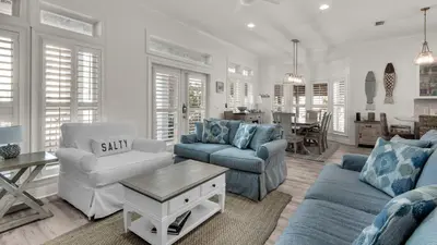 a living room with two couches and a table at Our Blue Haven in Inlet Beach