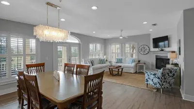 a dining room and living room with a table and chairs at Villas at Seagrove A202 - Sandcastles at Seagrove in Santa Rosa Beach