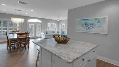 a kitchen and living room with a table and chairs at Villas at Seagrove A202 - Sandcastles at Seagrove in Santa Rosa Beach