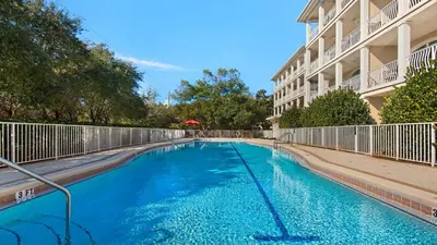 a swimming pool in front of a building at Villas at Seagrove A202 - Sandcastles at Seagrove in Santa Rosa Beach