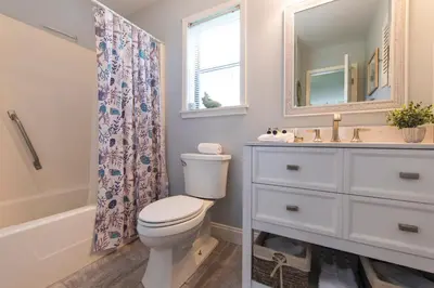 a bathroom with a toilet and a sink and a mirror at Beachwood Villas #9E - Sandy Cheeks in Santa Rosa Beach