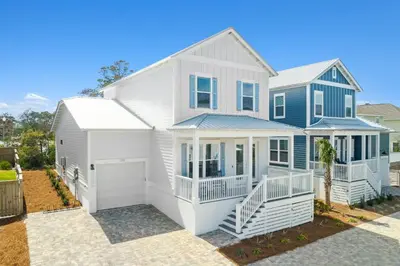 a white and blue house with a garage at 30A Beach House - Mira Bella in Rosemary Beach