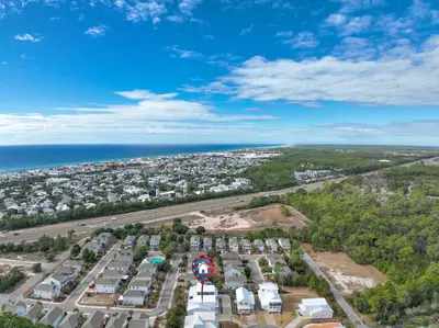 an aerial view of a parking lot next to the ocean at 30A Beach House - Mira Bella in Rosemary Beach