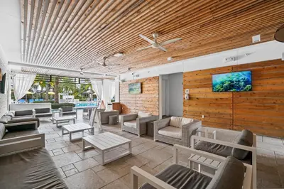 a living room with couches and a tv on a wall at The Pointe on 30A by Panhandle Getaways in Rosemary Beach