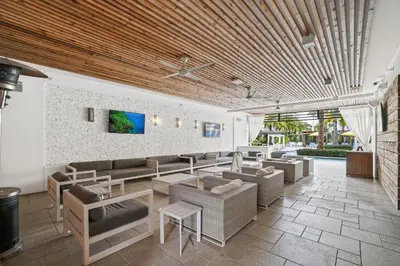 a living room with couches and tables and a tv at The Pointe on 30A by Panhandle Getaways in Rosemary Beach
