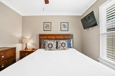 a bedroom with a white bed and a window at Pet Friendly Beach House - Paradise on Palm by Panhandle Getaways in Panama City Beach