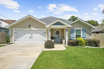 a house with a white garage at Pet Friendly Beach House - Paradise on Palm by Panhandle Getaways in Panama City Beach