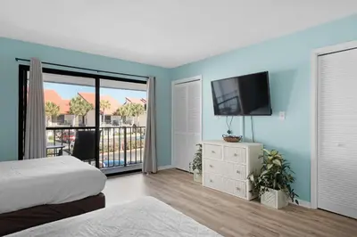 a bedroom with a bed and a flat screen tv at Edgewater Golf Villa 2110 in Panama City Beach