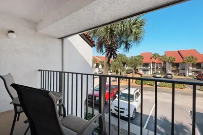 a balcony with a car parked in a parking lot at Edgewater Golf Villa 2110 in Panama City Beach