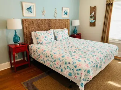 a bedroom with a bed with two night stands and two lamps at Amzg Gulf view,4 Bd/3.5 Bath Home, Pvt heated Pool in Panama City Beach