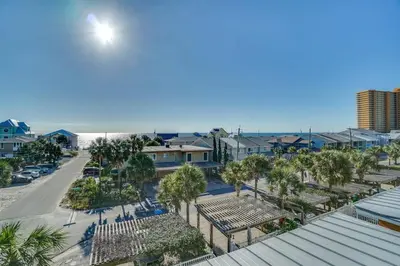 an aerial view of a parking lot with palm trees at Amzg Gulf view,4 Bd/3.5 Bath Home, Pvt heated Pool in Panama City Beach