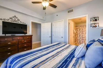 a bedroom with a bed and a flat screen tv at Beautiful Condo with Ocean View from 15th Floor in Panama City Beach