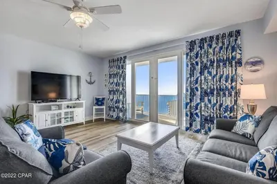 a living room with a couch and a tv at Beautiful Condo with Ocean View from 15th Floor in Panama City Beach