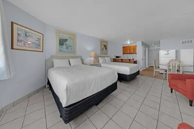 a hotel room with two beds and a kitchen at Top of the Gulf 416 in Panama City Beach