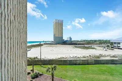 a view of a beach and a building at Top of the Gulf 416 in Panama City Beach