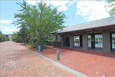 a brick sidewalk in front of a building at Magnolia Cottages by the Sea by Panhandle Getaways in Seacrest