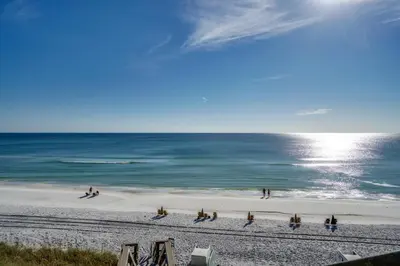 a group of people on a beach near the ocean at Magnolia Cottages by the Sea by Panhandle Getaways in Seacrest
