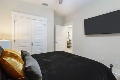a bedroom with a bed and a flat screen tv at Emerald-Gem-Inn • Laguna Haven/Beach Home! in Panama City Beach